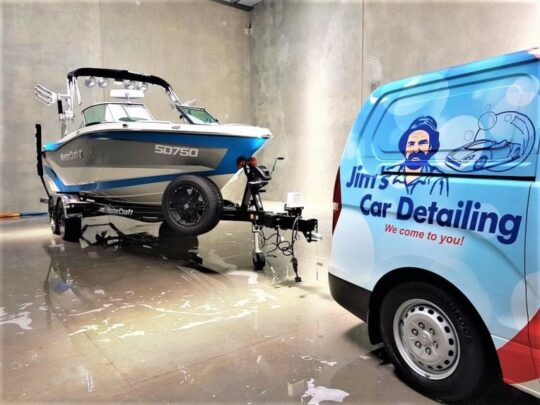 Jim’s Car Detailing service for boats, with branded van beside a detailed boat